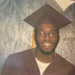 Young Black man in a graduation cap and gown