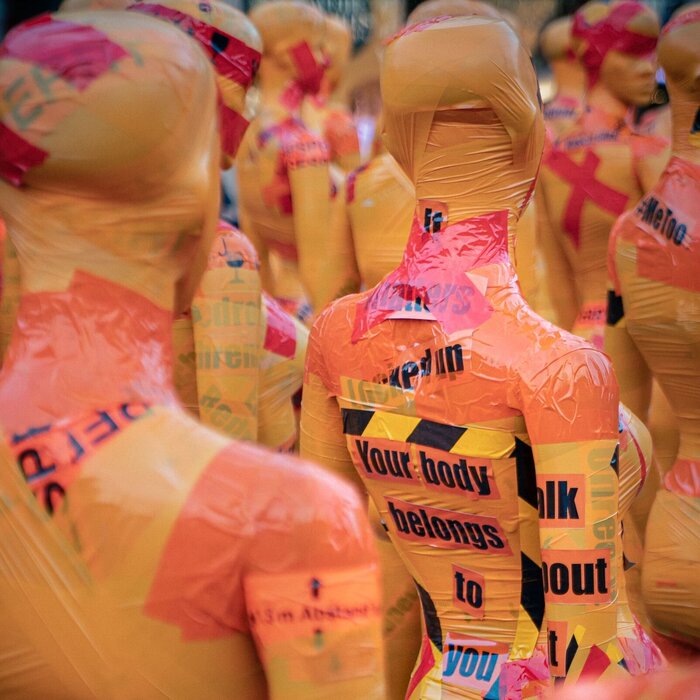 Mannequins covered with tape saying "Your body belongs to you"