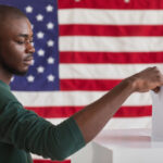 Black man voting in front of an American flag