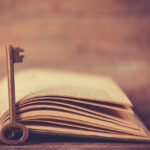 A key in front of a Bible