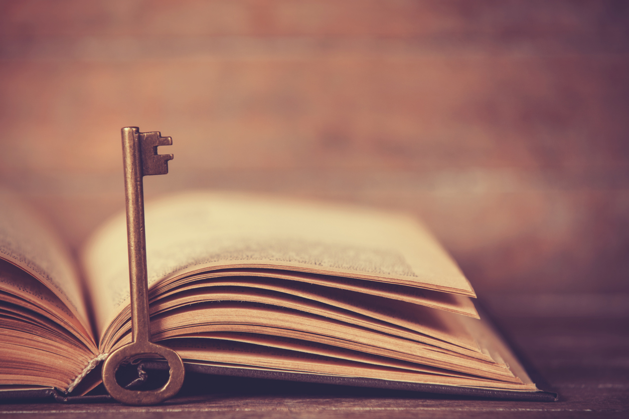 A key in front of a Bible