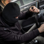 Car thief tries to start the car with a screwdriver in the ignition. Car thief, car theft