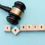 Judge's gavel knocking the "u" in justice out of place