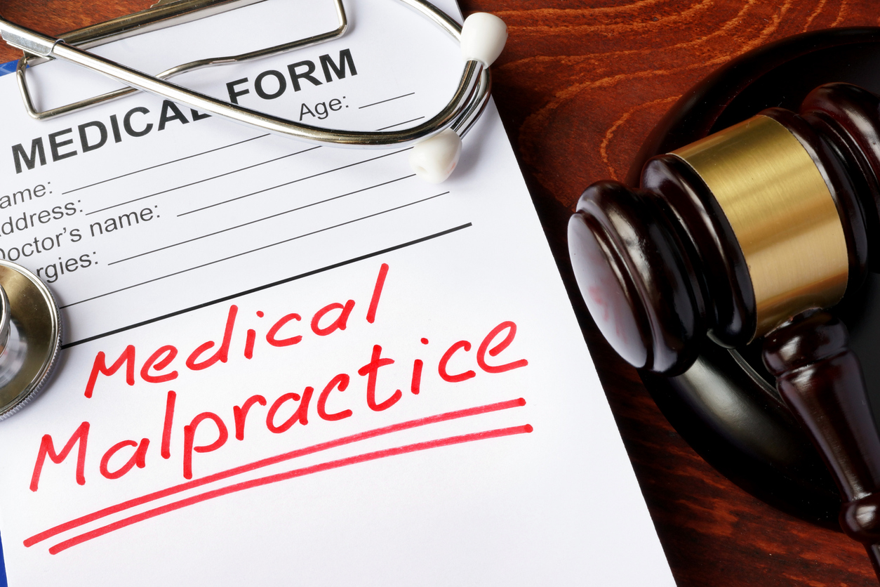 Medical form with words Medical Malpractice and gavel. Medical form with words Medical Malpractice and gavel.