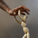 Statue of a human pushing against a hand attempting to hold it down